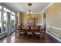Traditional dining room with hardwood floors, large window, and chandelier at 3410 Kates Way, Duluth, GA 30097