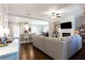 Spacious living room showcasing an open floor plan, with modern fireplace and views of the kitchen at 7738 Fawn Cir, Covington, GA 30014