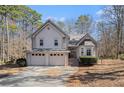 Charming two-story home with a three-car garage and well-maintained landscaping surrounded by mature trees at 146 Crowell Se Rd, Conyers, GA 30094