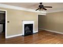 Inviting living room featuring a classic fireplace, hardwood floors, and a ceiling fan at 1867 Dresden Dr, Atlanta, GA 30319