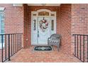 Charming front entrance featuring a decorative wreath and classic brick facade at 2287 Lake Ridge Ter, Lawrenceville, GA 30043