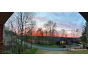 Picturesque street view at dusk with stunning sunset over the lake at 2287 Lake Ridge Ter, Lawrenceville, GA 30043
