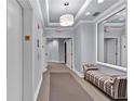 Well-lit hallway with neutral tones, plush seating, and decorative lighting, for a welcoming residential experience at 2828 Peachtree Nw Rd # 1402, Atlanta, GA 30305