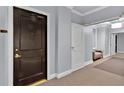Hallway featuring unit 1402, with soft lighting and a glimpse of comfortable seating ahead at 2828 Peachtree Nw Rd # 1402, Atlanta, GA 30305