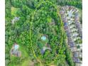 Aerial view of a private property, surrounded by a lush forest, with a beautiful backyard pool at 627 Rock Springs Rd, Lawrenceville, GA 30043