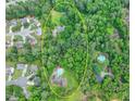 Expansive property featuring a large home with a private pool surrounded by lush greenery and mature trees at 637 Rock Springs Rd, Lawrenceville, GA 30043