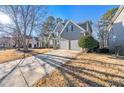 Beautiful home with a two-car garage, complemented by a well-manicured lawn and mature trees in a neighborhood at 4526 Balto Way, Acworth, GA 30101