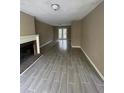Open-concept living area with a fireplace, french doors, and gray tile flooring at 4807 Hairston, Stone Mountain, GA 30088