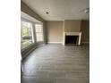 Bright living room featuring a bay window, fireplace and gray tile flooring at 4807 Hairston, Stone Mountain, GA 30088
