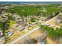 An aerial view showcases the property and the surrounding neighborhood's lush green landscape at 2295 Highway 81 North, Oxford, GA 30054
