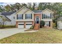 Charming two-story home with a well-manicured lawn, a two-car garage, and beautiful landscaping at 4224 Berkeley Mill Close, Duluth, GA 30096