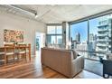 Bright and airy living room featuring hardwood floors, modern decor and stunning city views at 923 Peachtree Ne St # 1628, Atlanta, GA 30309