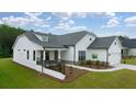 This single-Gathering home has a manicured lawn, a covered porch and an attached two-car garage at 1619 Tielman Way, Snellville, GA 30078