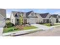 Beautiful home featuring a well-manicured lawn, a gray roof, light gray siding, and a two-car garage with an inviting driveway at 1649 Tielman Way, Snellville, GA 30078