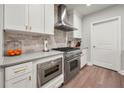 Bright kitchen with marble backsplash, stainless steel appliances and wood flooring at 270 17Th Nw St # 2804, Atlanta, GA 30363