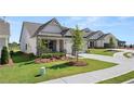 New construction home with attractive landscaping and gray exterior at 1629 Tielman Way, Snellville, GA 30078