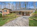 Traditional home showcasing a long driveway, neutral siding, and a welcoming covered front porch at 731 Fern Se St, Marietta, GA 30067