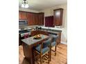 Cozy kitchen featuring granite countertops, stainless steel appliances, and a center island at 4038 Se Clay Court Se Se, Conyers, GA 30013