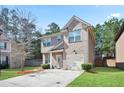 Lovely two-story home featuring a combination of brick and siding, a well-kept lawn, and a driveway at 5884 Grande River Rd, Atlanta, GA 30349