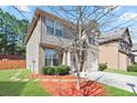 Side view of the home showing the well-manicured lawn and brick and siding exterior at 5884 Grande River Rd, Atlanta, GA 30349