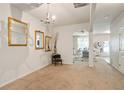 Open-concept living room with neutral walls, carpet flooring and decorative mirrors at 5884 Grande River Rd, Atlanta, GA 30349