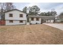 Charming two-story home with freshly painted exterior and a convenient carport at 7445 Paul Ct, Riverdale, GA 30274