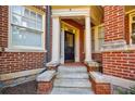 Close up of the doorway to a red brick apartment building with steps leading to the entrance at 198 Ponce De Leon Ne Ave # 5D, Atlanta, GA 30308