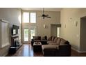 Bright living room featuring a fireplace, vaulted ceilings, and access to the backyard at 2820 Skye Ter, Duluth, GA 30096