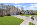 Attractive home featuring a well-maintained lawn, a two-car garage, and traditional brickwork at 330 Meadowcrest Cir, Canton, GA 30115