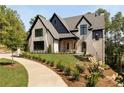 Beautiful two-story home with manicured lawn and inviting entryway at 6055 Tattnall Overlook, Acworth, GA 30101