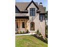 Close-up of charming brick house front with arched door at 6055 Tattnall Overlook, Acworth, GA 30101