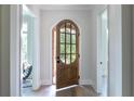Inviting entryway showcasing an arched doorway with a wooden door at 64 Telfair Ct, Acworth, GA 30101