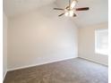 Spacious bedroom with vaulted ceilings, modern fan, and neutral carpeting for a cozy feel at 844 Glenshire Ct, Riverdale, GA 30274