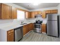 Well-lit kitchen with stainless steel appliances, light countertops, and classic wood cabinetry at 844 Glenshire Ct, Riverdale, GA 30274