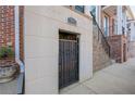 Basement entrance with a gated door with '961' on wall, part of brick front home at 961 Persimmon Pt, Atlanta, GA 30328