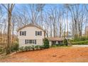 Charming two-story home with neutral siding, brick accents, dark shutters and a well-maintained front yard at 345 W Spalding Dr, Atlanta, GA 30328