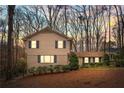 Inviting two-story home with classic siding, blue shutters, and a meticulously maintained front yard at 345 W Spalding Dr, Sandy Springs, GA 30328