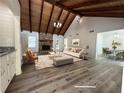 Bright living room features a wood beamed ceiling, stone fireplace, and an adjacent dining area at 3559 Sawmill Ter, Marietta, GA 30062