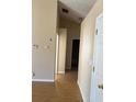 Hallway with laminate flooring leading to additional rooms and an open floor plan at 740 Kibbe Cir, Lawrenceville, GA 30044