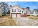 Charming two-story home with vinyl siding, brick foundation, and a two-car garage in a suburban neighborhood at 1947 Phillips Lake Blf, Lithonia, GA 30058