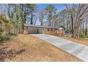 View of a well-maintained home, showcasing its covered parking and inviting front porch at 5277 Cardinal Nw Ln, Lilburn, GA 30047
