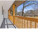 Inviting front porch with natural wood railing, perfect for enjoying the outdoors at 5277 Cardinal Nw Ln, Lilburn, GA 30047