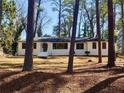 One-story house nestled in a wooded area, featuring a brick exterior and a welcoming front entrance at 1332 Willis Mill Sw Rd, Atlanta, GA 30311