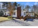 View of the exterior with a brick chimney and wooden ramp that leads to the front of the house at 5812 Dogwood Cir, Austell, GA 30168