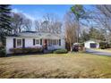 Quaint home with red front door, black shutters, and a detached garage accessible by a ramp at 5812 Dogwood Cir, Austell, GA 30168