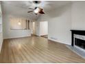 Bright living room featuring hardwood floors, a fireplace, and a ceiling fan at 832 Overlook Trl, Canton, GA 30115