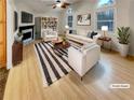 Bright, staged living room featuring vaulted ceilings, fireplace, and modern furnishings at 832 Overlook Trl, Canton, GA 30115