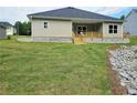 Well-maintained backyard featuring a covered patio and lush green lawn, perfect for outdoor living and entertaining at 112 Scarlett Place Dr, Bowdon, GA 30108