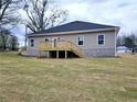 A backyard featuring an elevated wooden deck, neutral vinyl siding, and windows that offer plenty of natural light at 116 Scarlett Place Dr, Bowdon, GA 30108