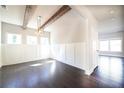 Bright dining room with dark hardwood floors, paneled walls, exposed beams, and modern light fixture at 2076 Greenridge Se Rd, Smyrna, GA 30080